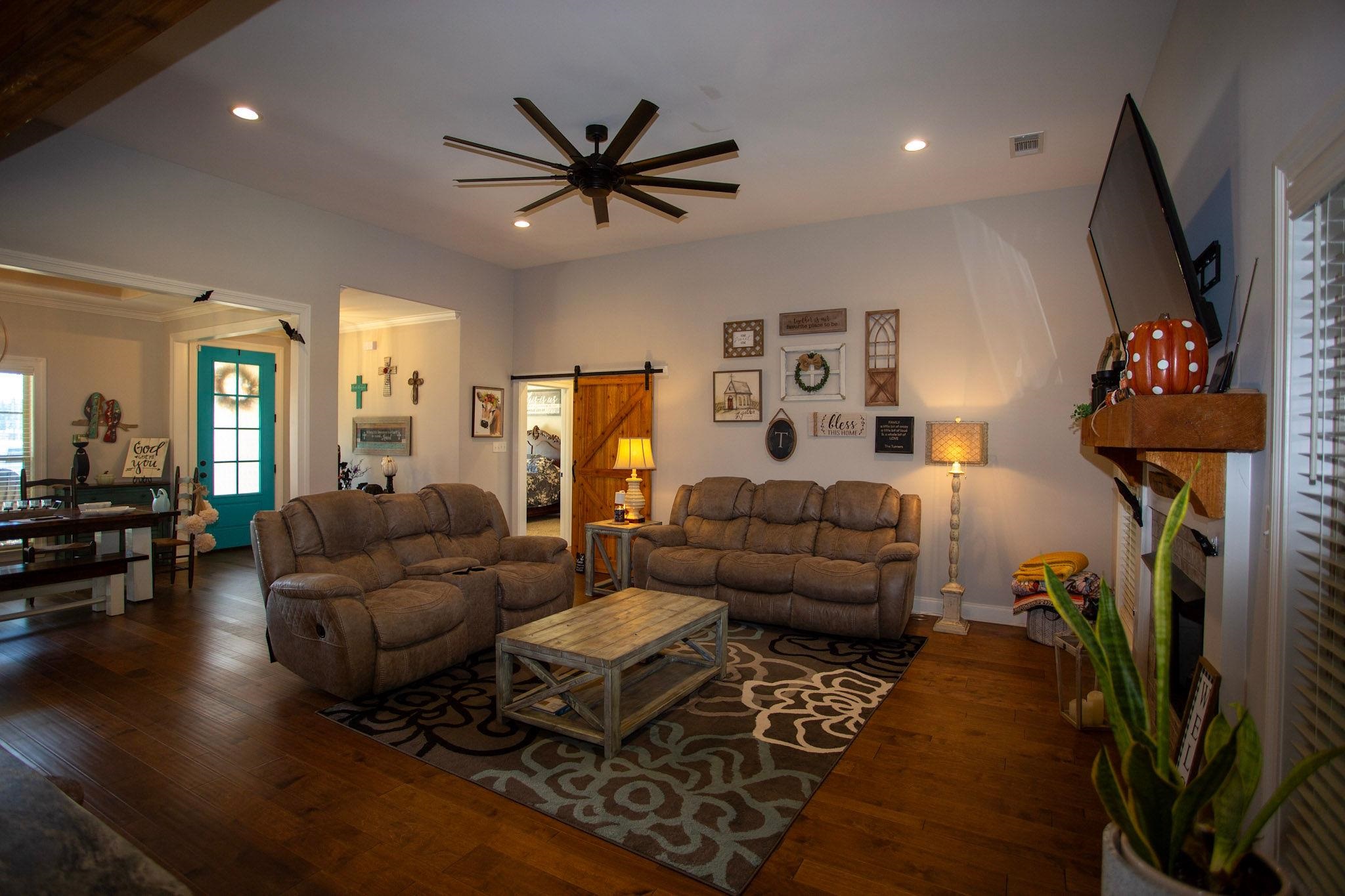 22 Cedar Ridge Cove Atoka, TN 38004 - Photo 7 of 39 Living room featuring dark hardwood / wood-style floors, a barn door, and ceiling fan