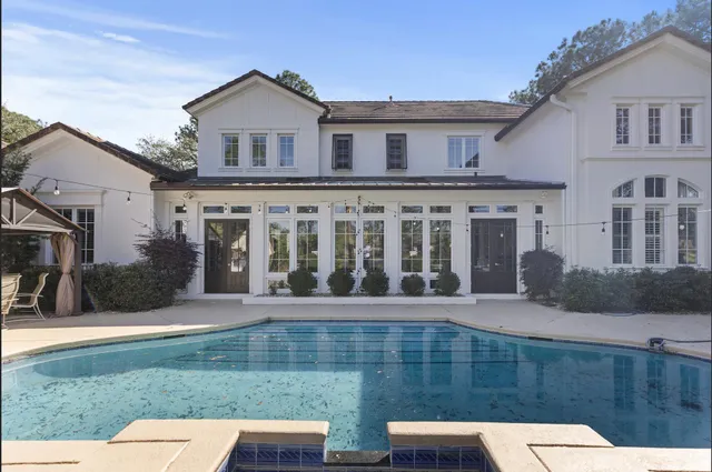 a view of a white building among the yard