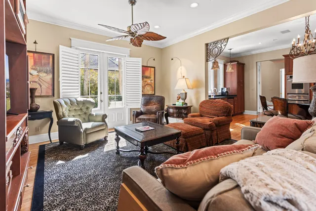 a living room with furniture and large windows