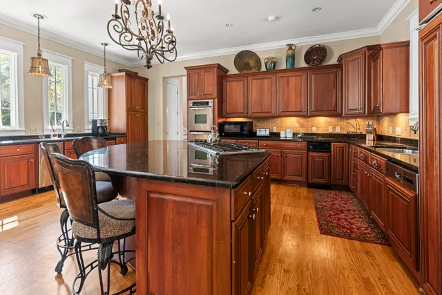 a living room with furniture floor to ceiling window and couch