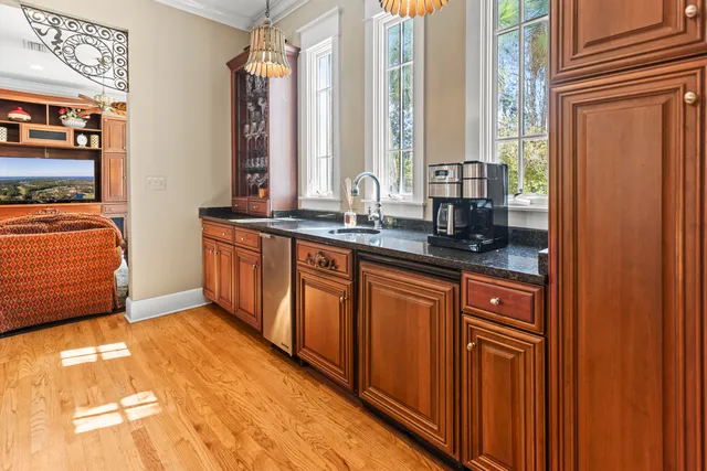 a bedroom with a bed a large window and book shelf