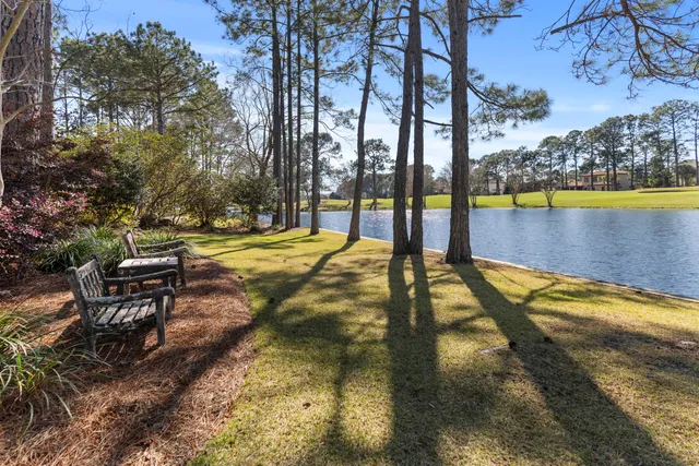 a view of swimming pool with seating area and trees around
