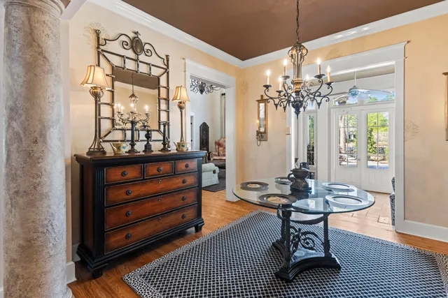 a living room with furniture and a chandelier