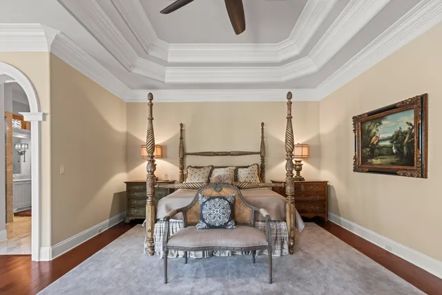 a living room with furniture chandelier and a large window