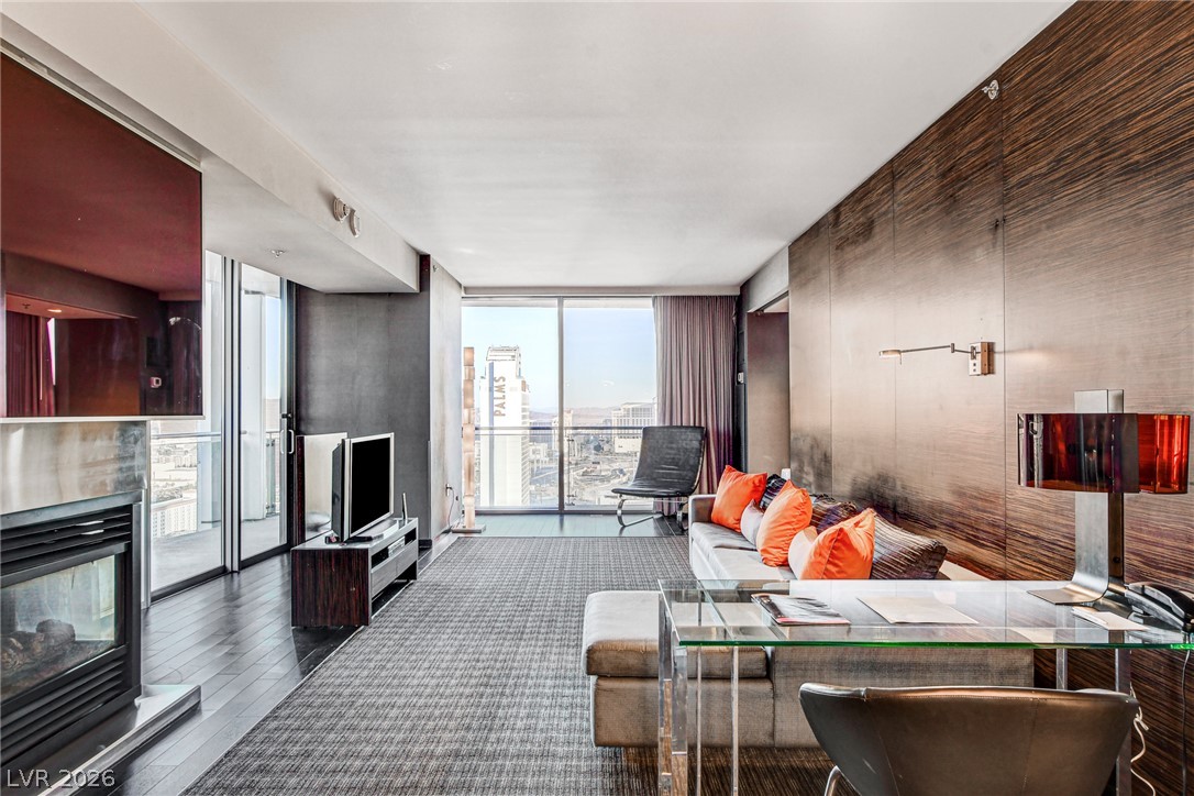 4381 West Flamingo Road, Unit 3002 Las Vegas, NV 89103 - Photo 44 of 59 Gleaming wood floors and a contemporary fireplace define this modern high-rise living space.