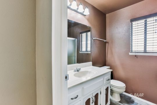 236 Richard Court Ridgecrest, CA 93555 - Photo 19 of 29 a bathroom with a sink and toilet