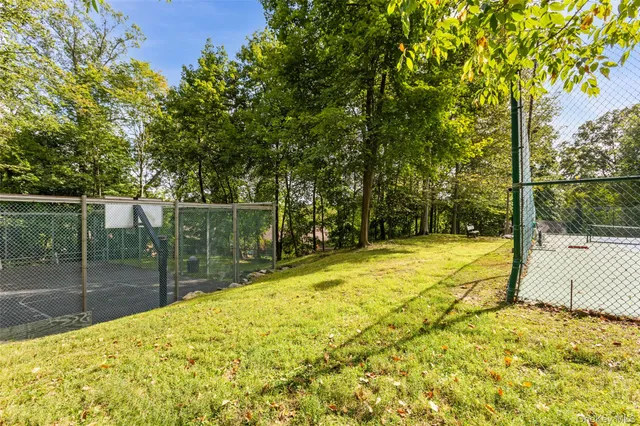 a swimming pool with outdoor seating and yard
