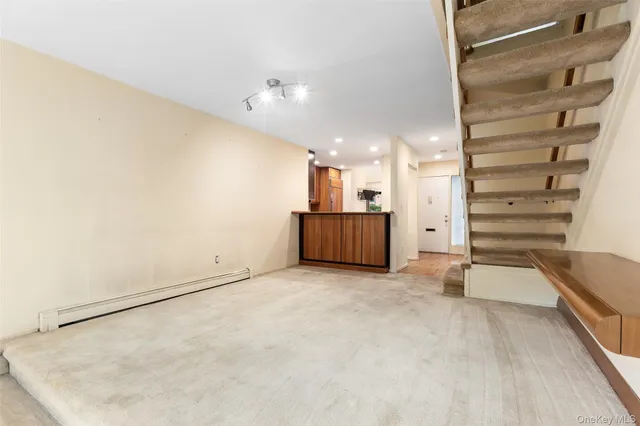 an empty room with shelves and wooden floor