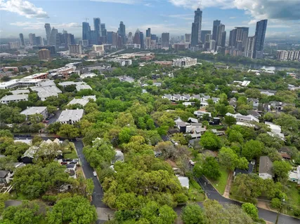 an aerial view of residential houses with city view