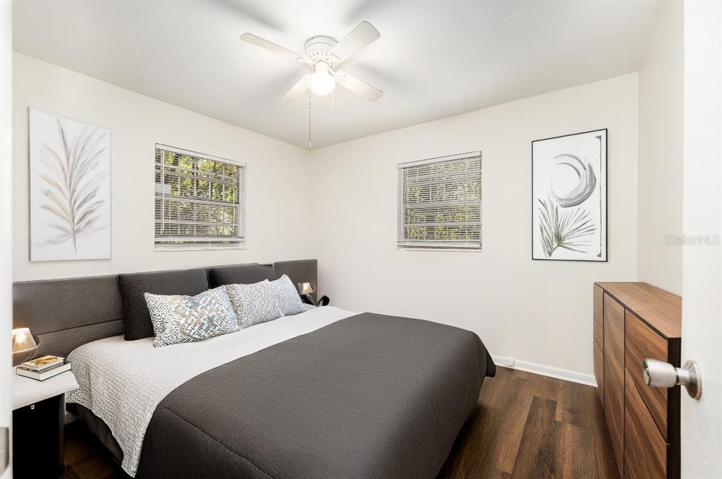 2511 Northeast 3rd Place Gainesville, FL 32641 - Photo 18 of 29 a bedroom with a large bed and a chandelier