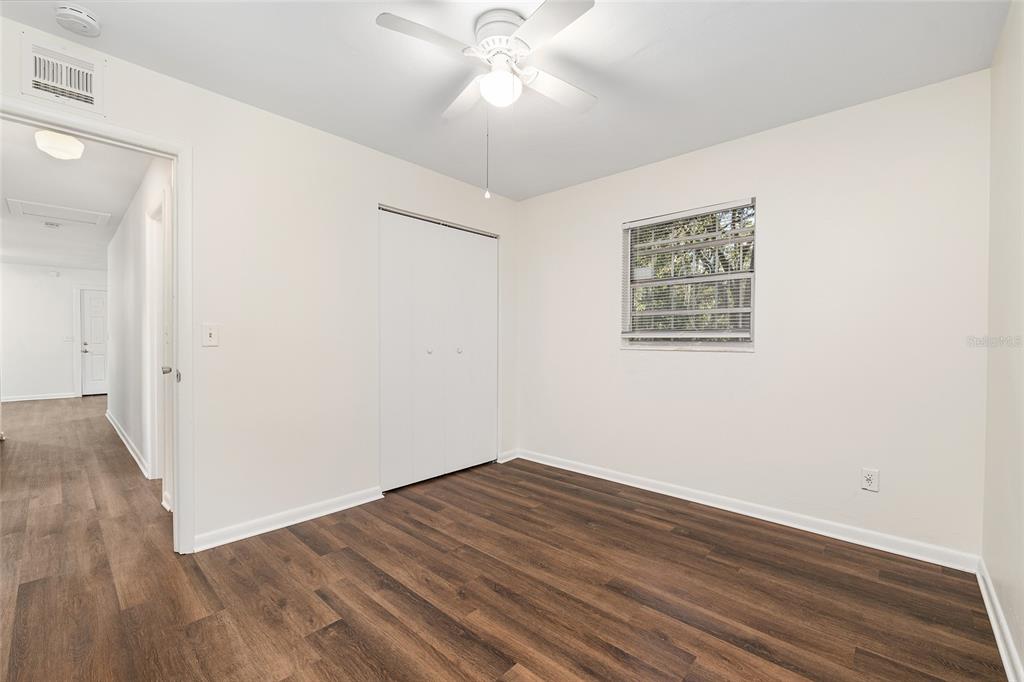 2511 Northeast 3rd Place Gainesville, FL 32641 - Photo 19 of 29 an empty room with wooden floor and windows