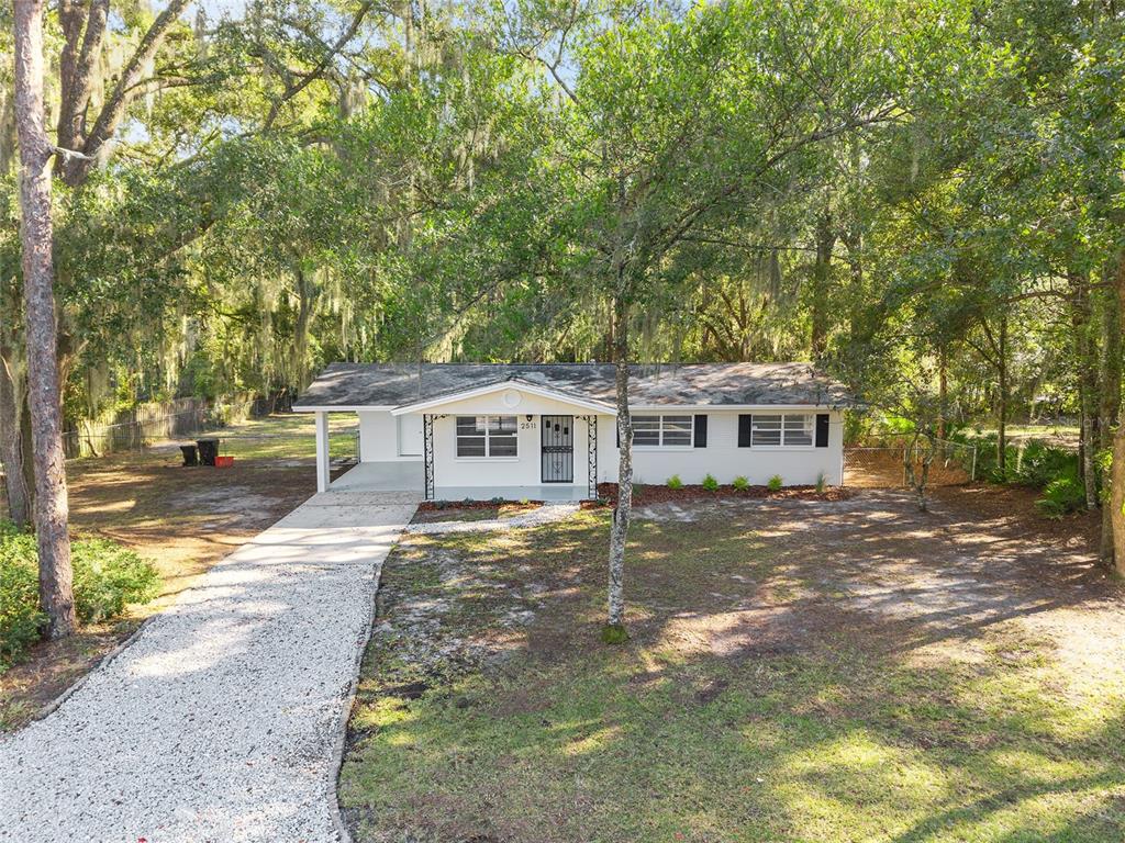 2511 Northeast 3rd Place Gainesville, FL 32641 - Photo 28 of 29 a view of a yard in front of a house with large trees