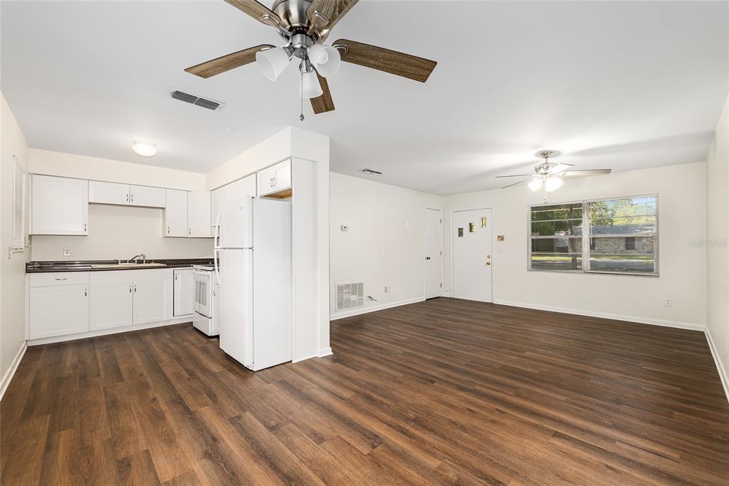 2511 Northeast 3rd Place Gainesville, FL 32641 - Photo 7 of 29 a view of an empty room with window and wooden floor