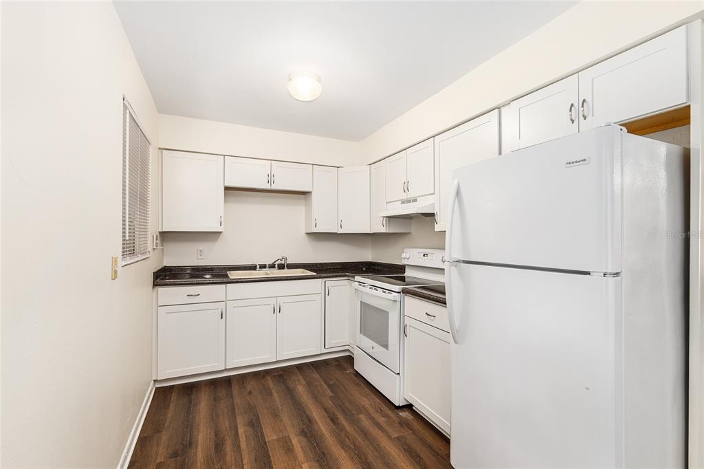 2511 Northeast 3rd Place Gainesville, FL 32641 - Photo 9 of 29 a white refrigerator freezer sitting inside of a kitchen