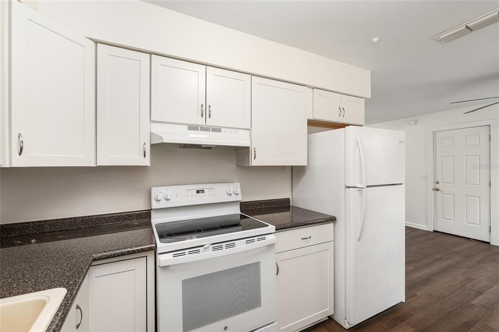 2511 Northeast 3rd Place Gainesville, FL 32641 - Photo 10 of 29 a kitchen with white cabinets and white appliances