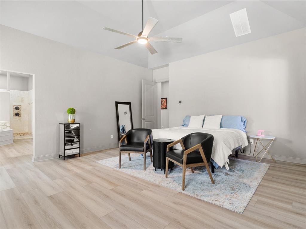 111 Old Base Road Aurora, TX 76078 - Photo 14 of 38 Private primary suite featuring generous square footage, natural light, and peaceful backyard views.