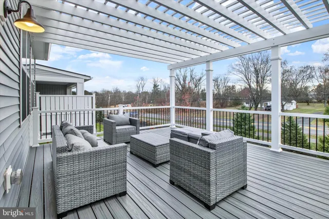 a balcony with furniture and wooden floor