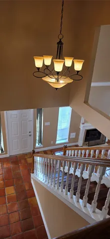 a view of a balcony with furniture and chandelier