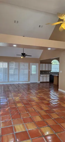 a view of empty room with wooden floor and cabinet