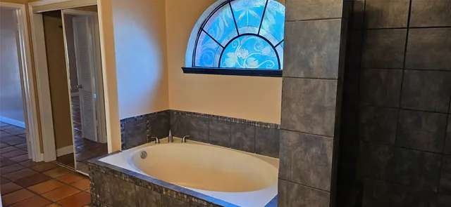 a bathroom with a tub and shower