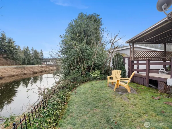 a backyard of a house with table and chairs