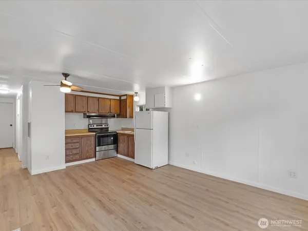 a kitchen with a refrigerator and a stove top oven