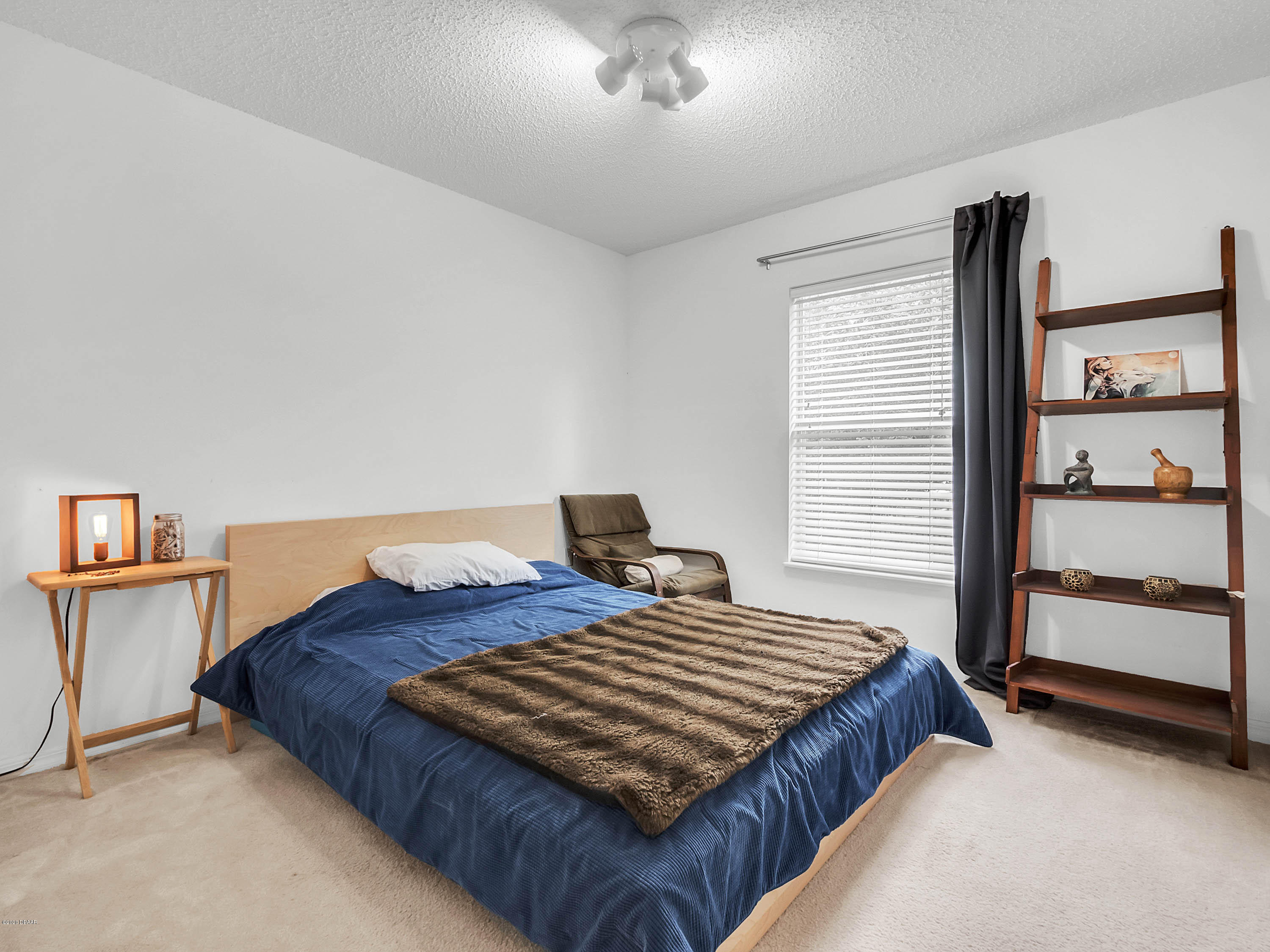 1982 7th Avenue DeLand, FL 32724 - Photo 19 of 36 a bedroom with a bed and a dresser