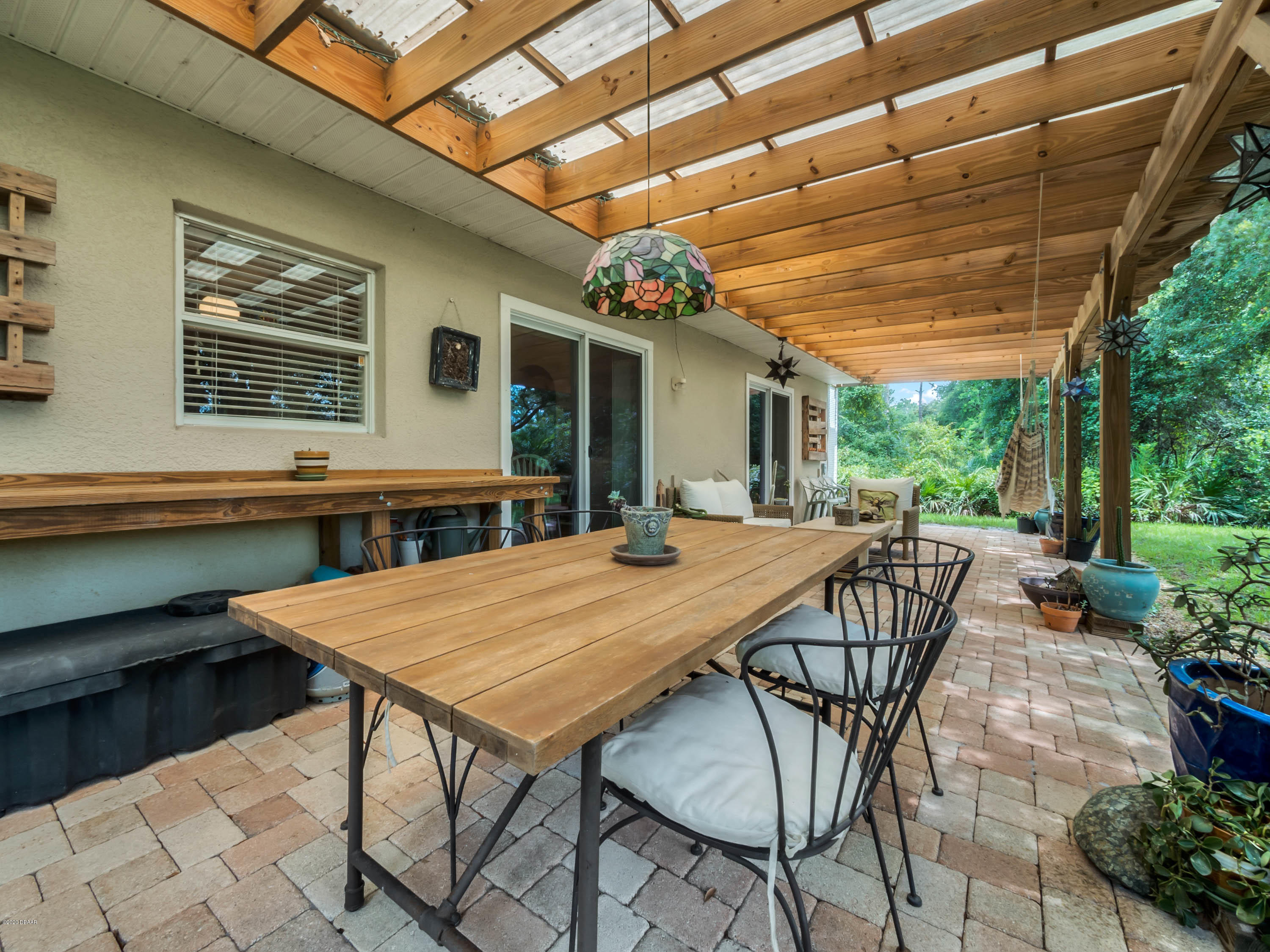 1982 7th Avenue DeLand, FL 32724 - Photo 28 of 36 a view of a patio with a table and chairs and potted plants