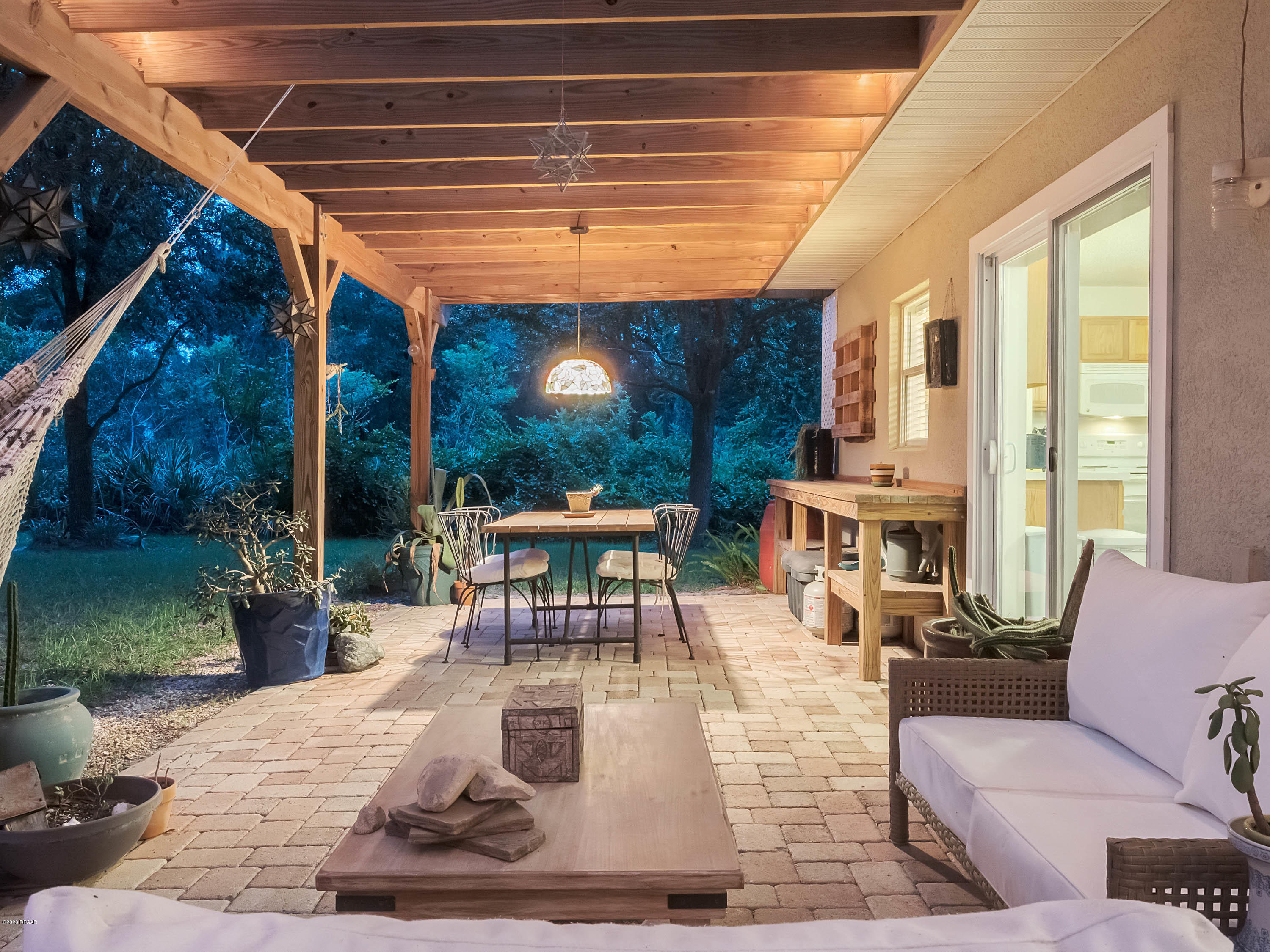 1982 7th Avenue DeLand, FL 32724 - Photo 36 of 36 a view of a patio with couches table and chairs and potted plants