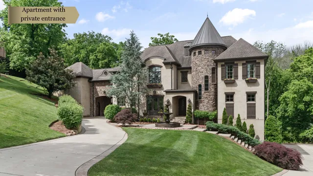 a front view of a house with yard and parking