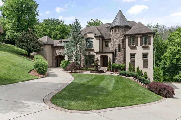 a front view of a house with a yard table and chairs