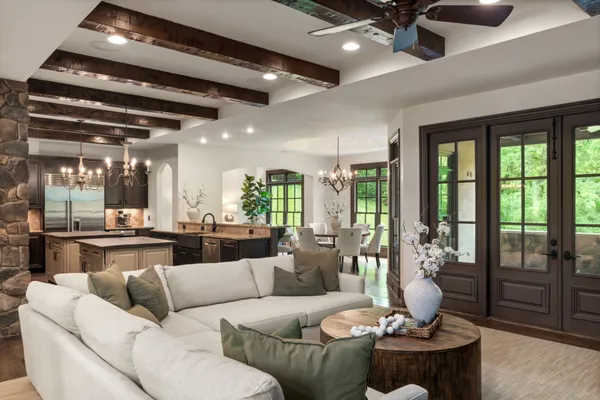 a dining room with furniture potted plants and wooden floor
