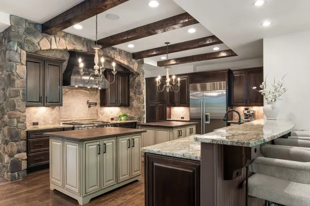 a bedroom with a large bed and a chandelier