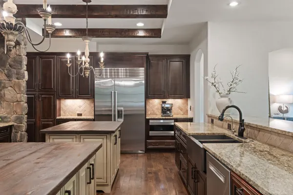 a bedroom with a large bed and a chandelier