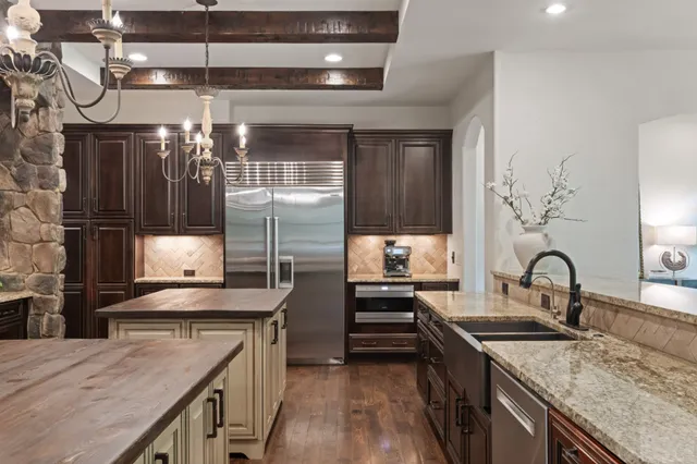 a spacious bedroom with a bed and a flat screen tv