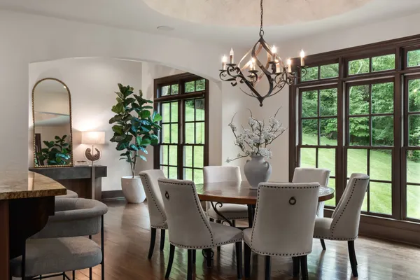 a living room with furniture a window and a chandelier