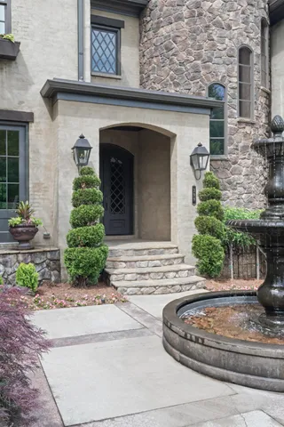 a living room with furniture a large window and a fireplace