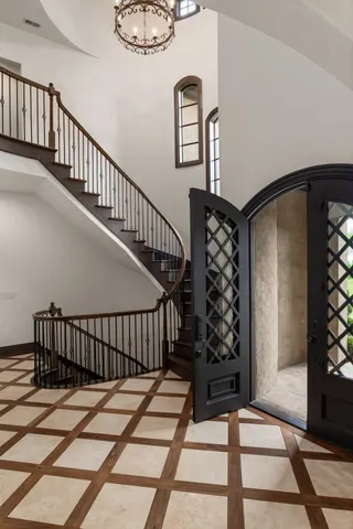 a living room with furniture a fireplace and a floor to ceiling window