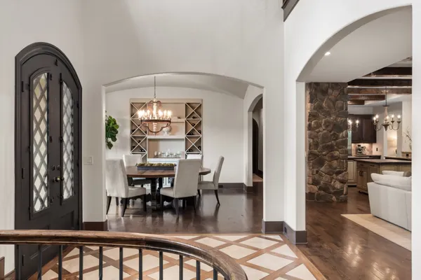 a living room with furniture a fireplace and a floor to ceiling window