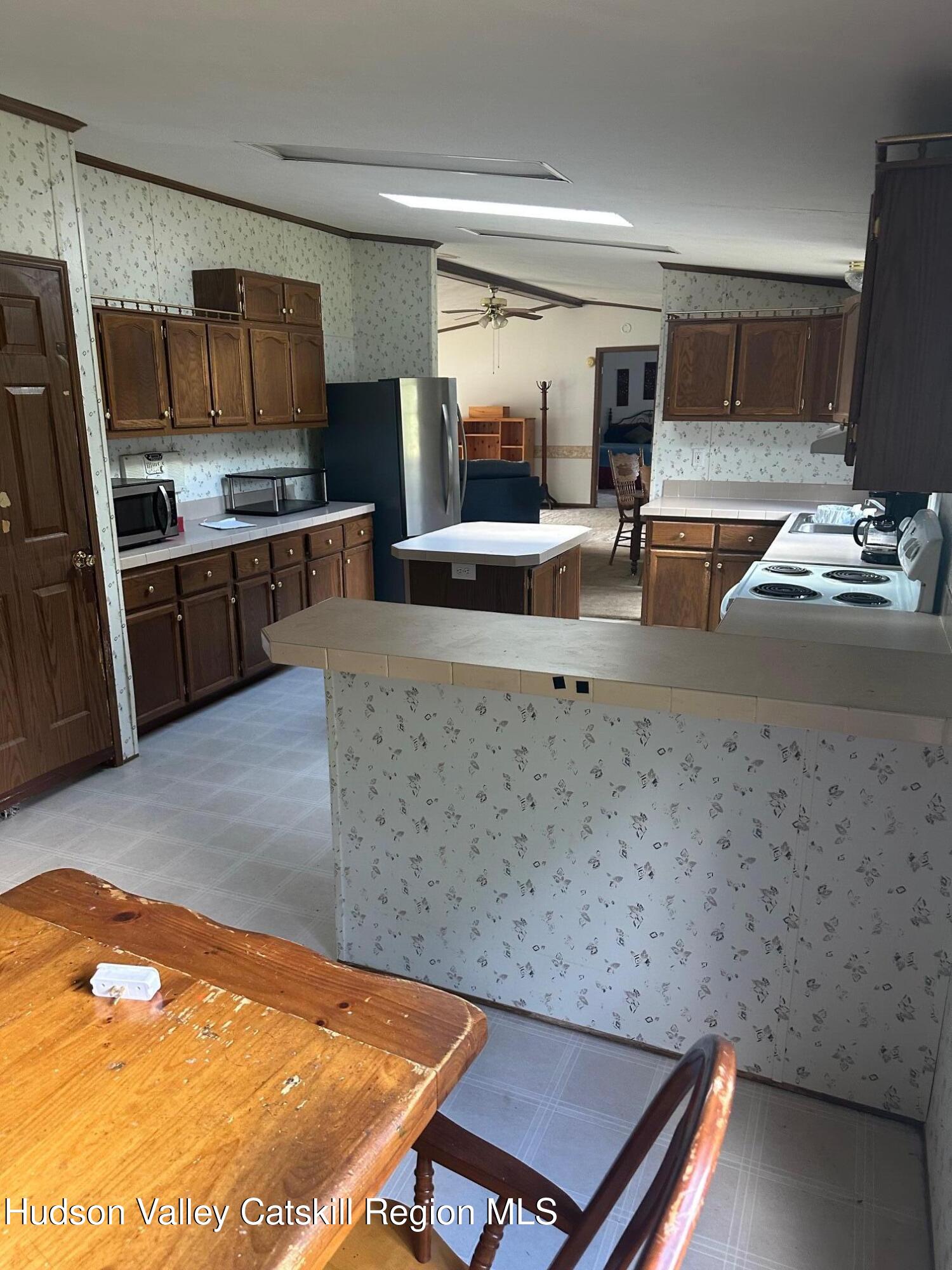3285 Middlebrook Hill Road Jefferson, NY 12093 - Photo 3 of 16 a kitchen with stainless steel appliances granite countertop a sink stove and refrigerator
