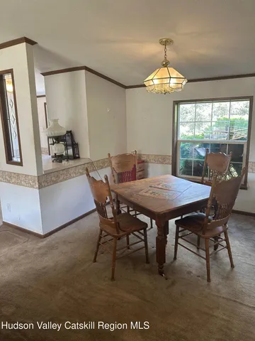 a view of a dining room with furniture and chandelier