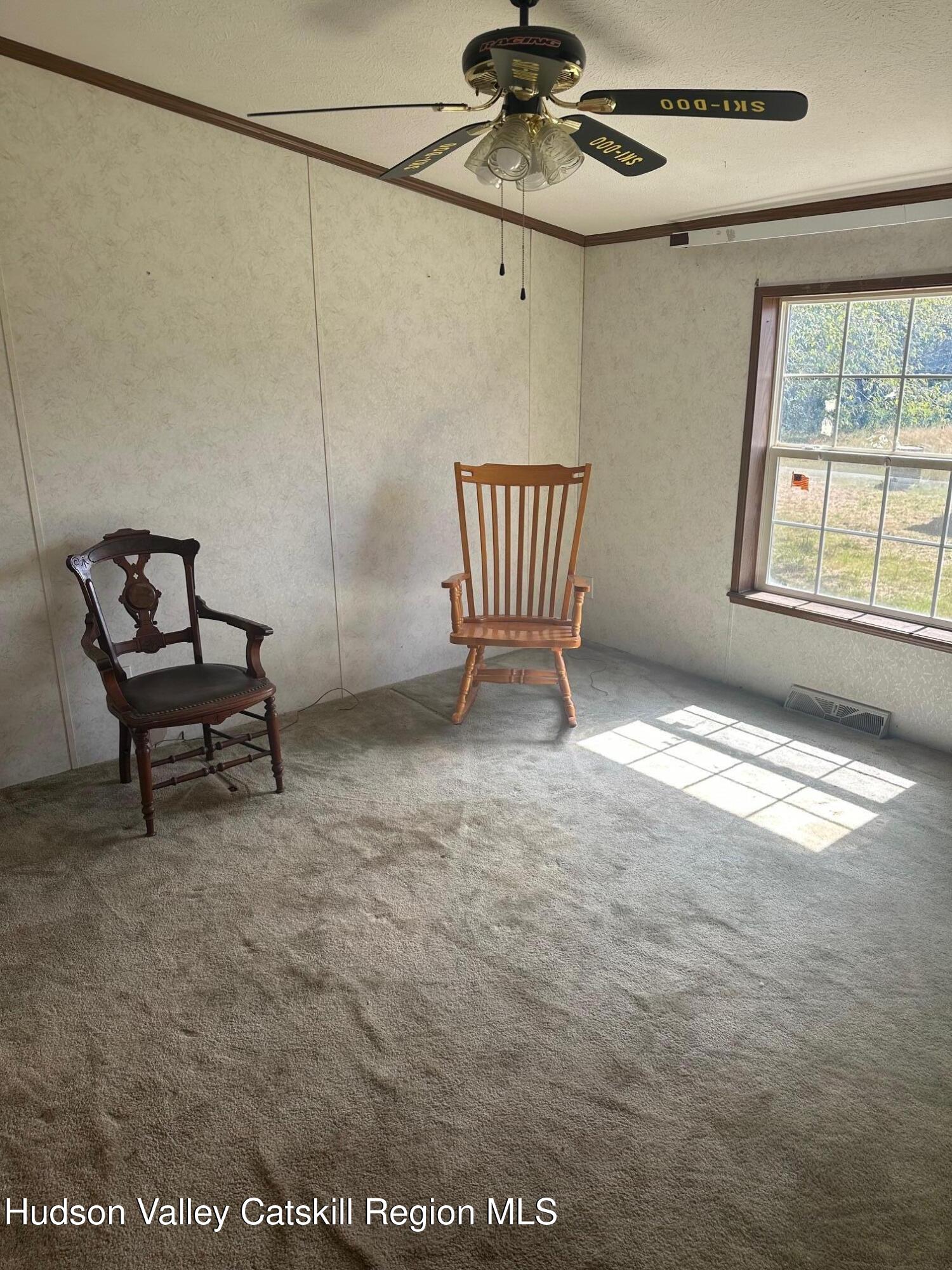3285 Middlebrook Hill Road Jefferson, NY 12093 - Photo 9 of 16 a view of an empty room with a window and furniture