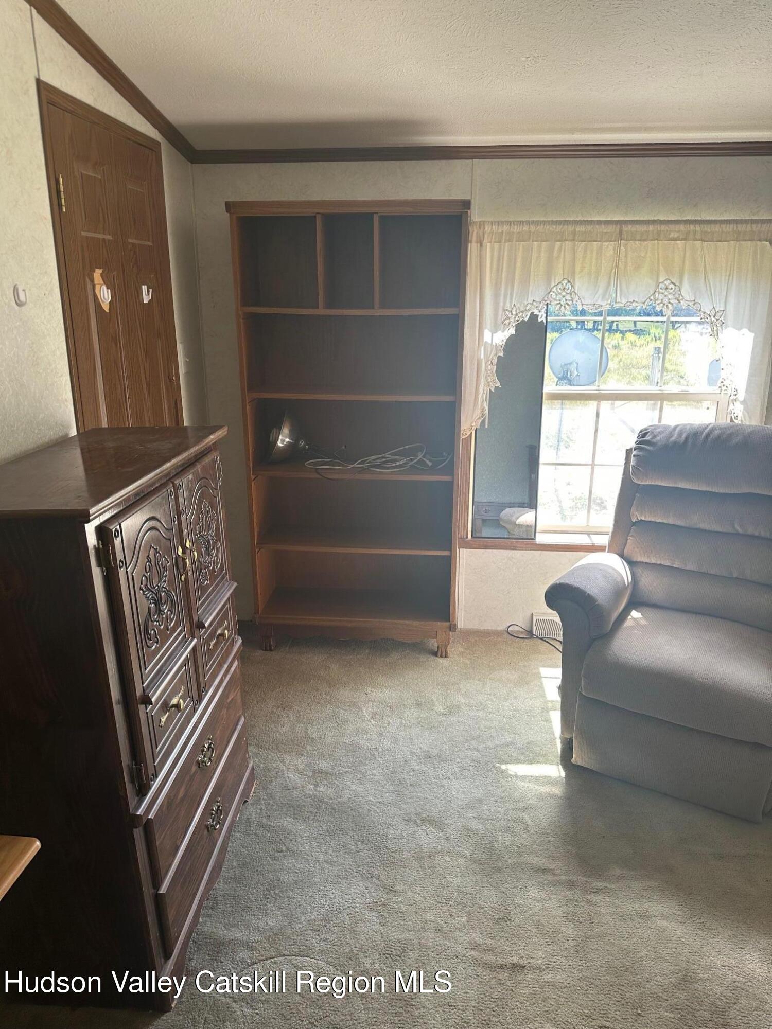 3285 Middlebrook Hill Road Jefferson, NY 12093 - Photo 10 of 16 a living room with furniture and a window