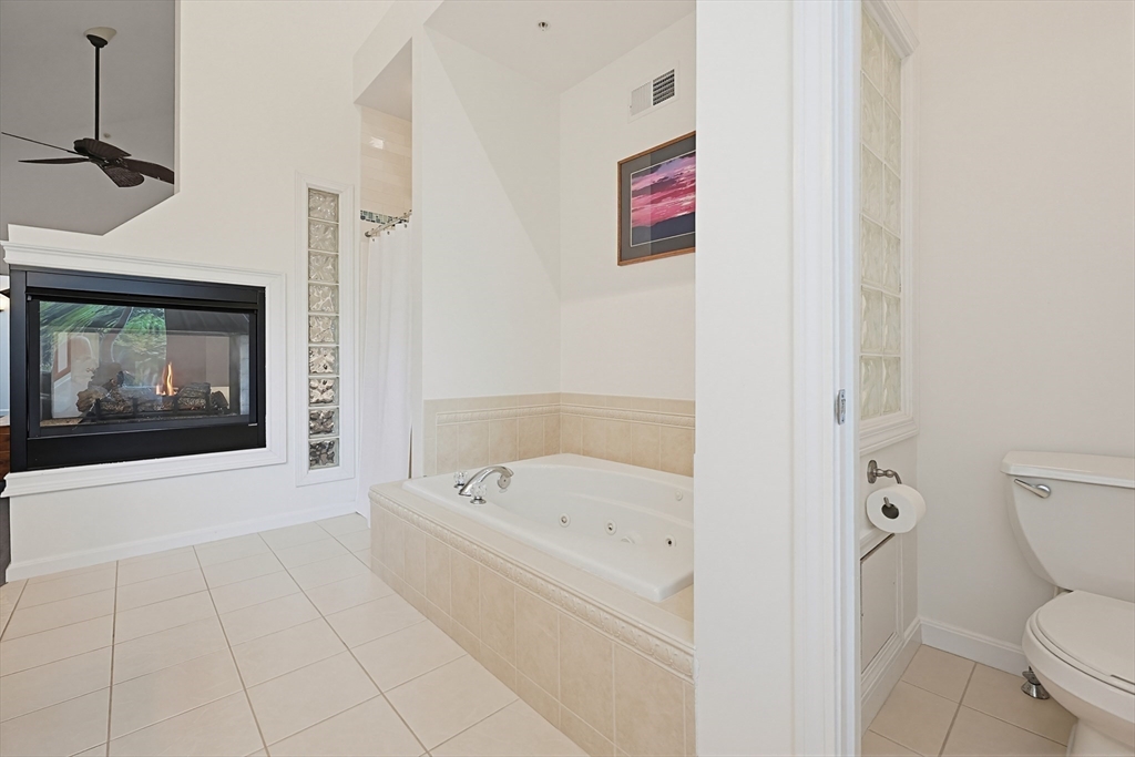 3002 Maple Brook Road, Unit 3002 Bellingham, MA 02019 - Photo 25 of 42 a white bath tub sitting next to a toilet