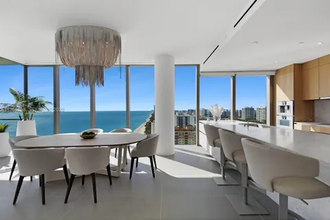 a living room with a bed furniture and a flat screen tv