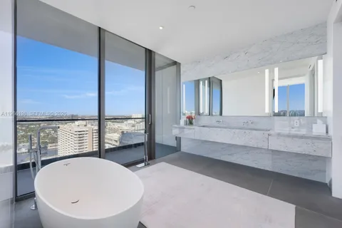 a bedroom with a bed and a view of balcony