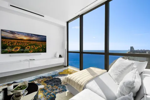 a large white kitchen with a large window