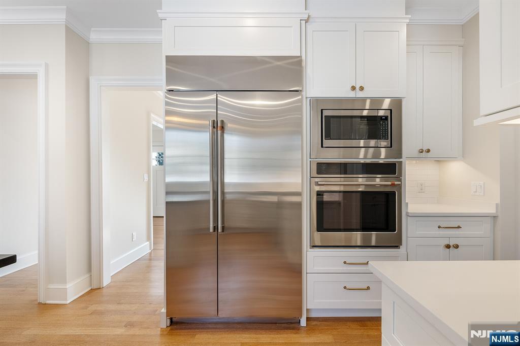 62 Colony Avenue Park Ridge, NJ 07656 - Photo 15 of 50 a kitchen with cabinets and stainless steel appliances