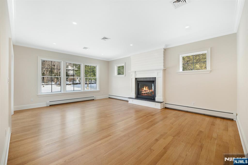 62 Colony Avenue Park Ridge, NJ 07656 - Photo 17 of 50 an empty room with wooden floor and a window
