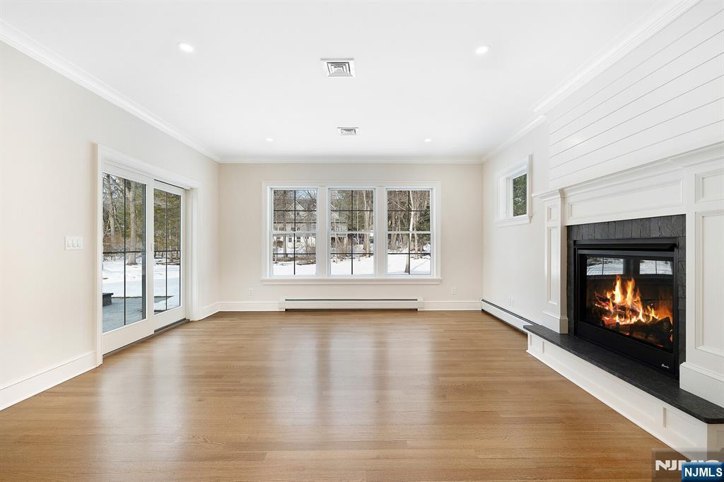 62 Colony Avenue Park Ridge, NJ 07656 - Photo 18 of 50 a view of an empty room with wooden floor and a window